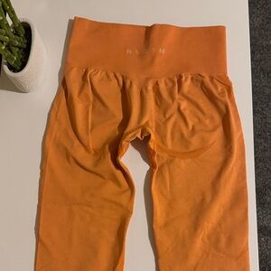 NVGTN Orange high waisted yoga pants .